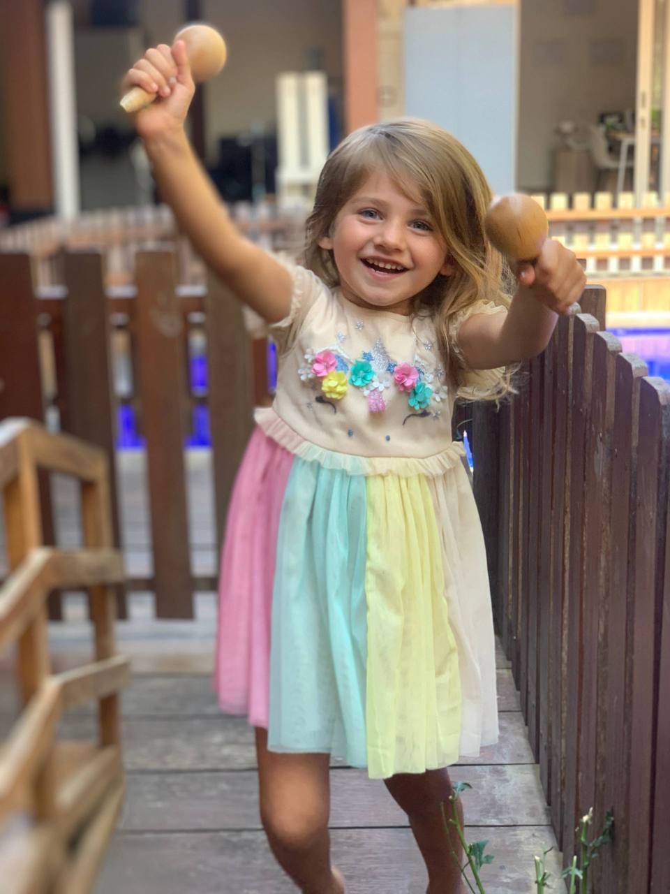 Happy preschool child playing with maracas