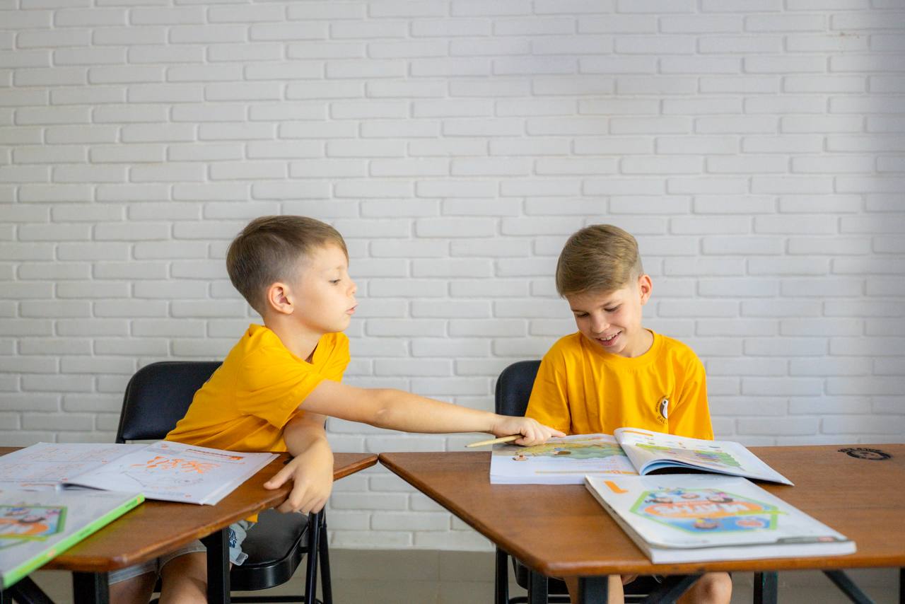 Two children working together on a project in the Balu Kids Primary Education Program